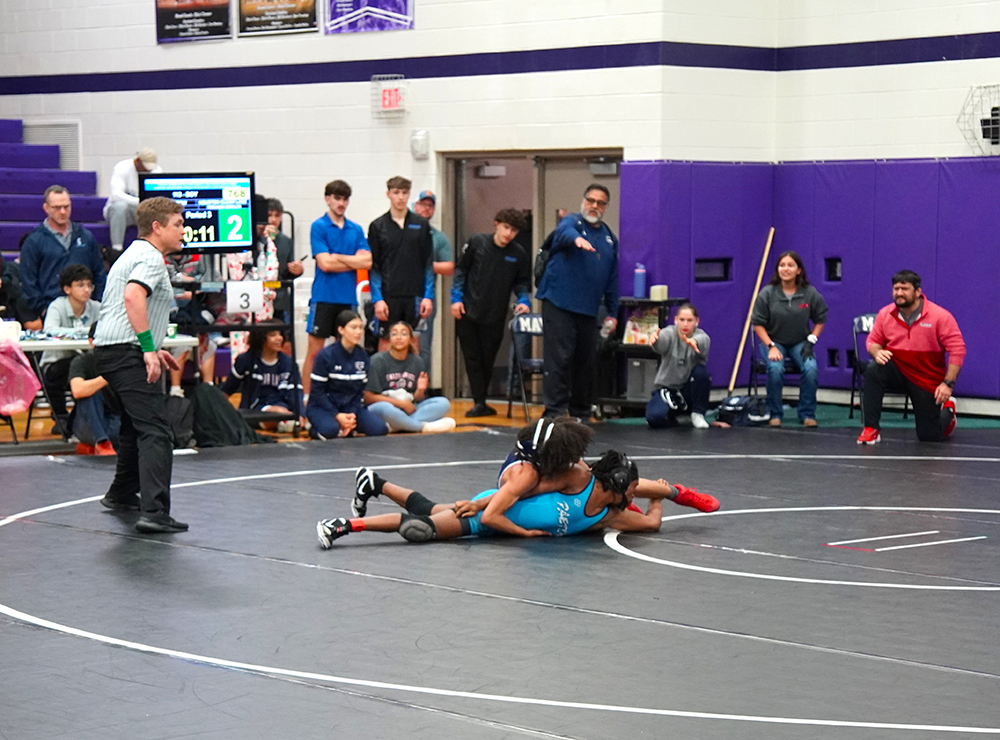 113 lb champ Fernando Morales of Clear Lake coming around for winning takedown.