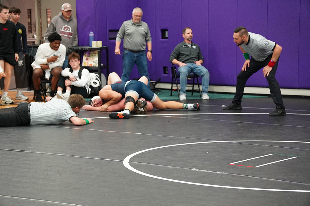 215 lb Roman Nino getting the pin over JP Smith while being dodwn 12-8