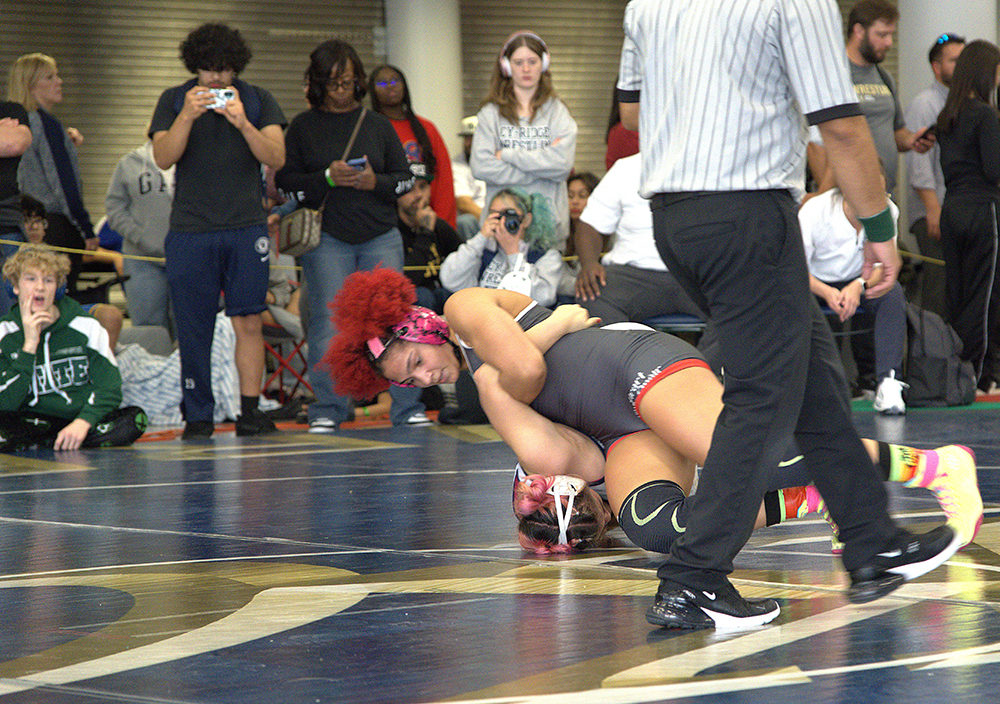 155 lb champion Claire Guydon turning her opponent
