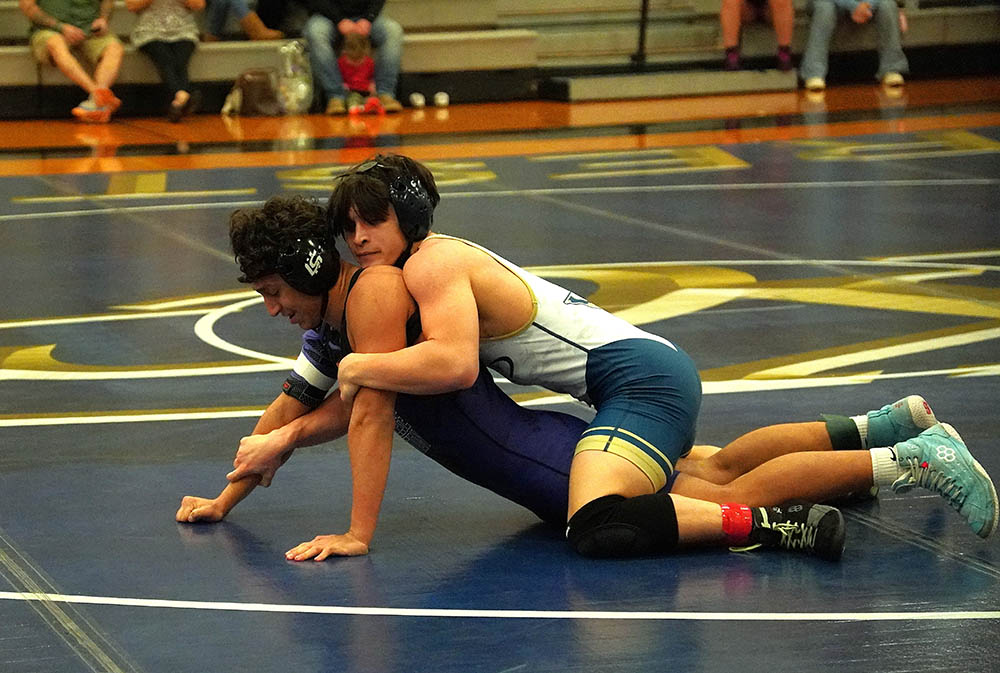 Keegan Pledger keeps the pressure on Gunner Watson.